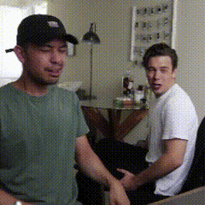 Man In Black Hat Talking To Another Man GIF