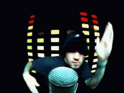 Man In Black Hat Waving At Microphone GIF