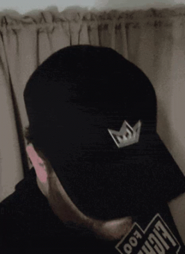 Man In Black Hat With Crown And Foo Shirt GIF
