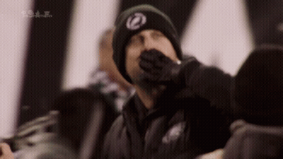 Man In Black Hat With Z Covering Mouth GIF