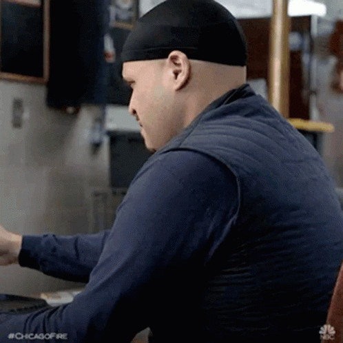 Man In Black Headband Using Laptop GIF