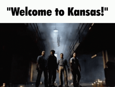 Man In Black Helmet And Tuxedo Beside Another Man GIF