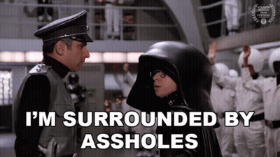 Man In Black Helmet Surrounded By Assholes GIF