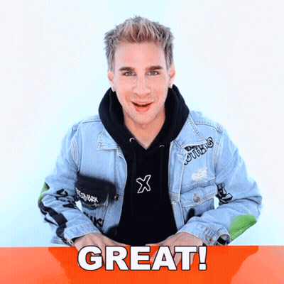 Man in Black Hoodie and Blue Denim Jacket in Front of Great Sign
