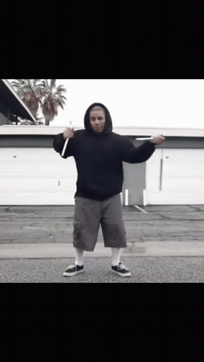 Man In Black Hoodie And Grey Shorts In Front Of Garage Door 29 GIF