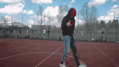 Man In Black Hoodie And Red Mask Walking GIF