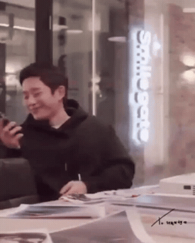 Man In Black Hoodie Holding Cell Phone GIF