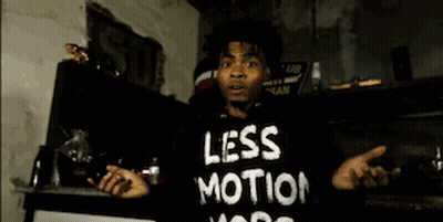 Man In Black Hoodie In Front Of Brick Wall GIF