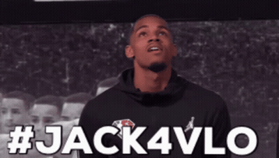 Man In Black Hoodie In Front Of Jack4Vlo Sign GIF