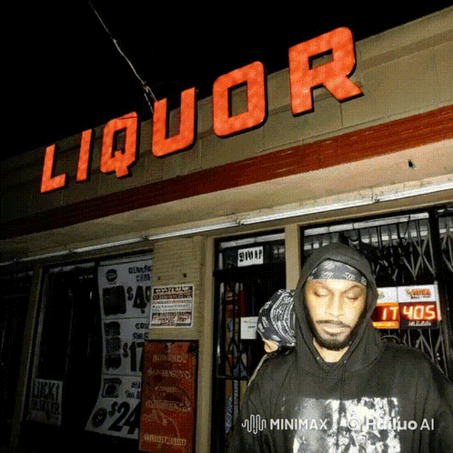 Man In Black Hoodie In Front Of Liquor Store GIF