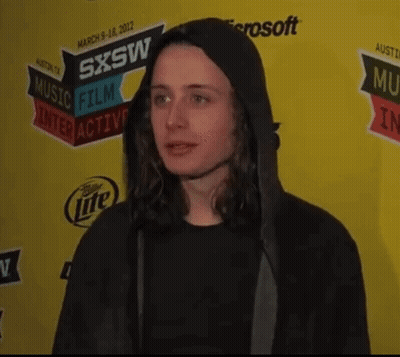 Man In Black Hoodie In Front Of SXSW Sign GIF