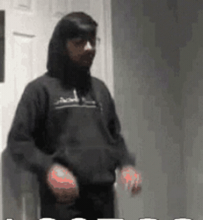 Man In Black Hoodie In Front Of White Door GIF