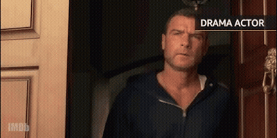 Man In Black Hoodie Standing In Front Of Drama Actor Sign GIF
