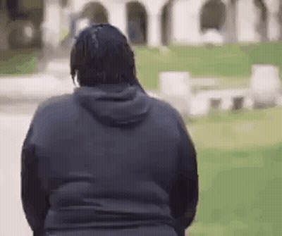 Man In Black Hoodie Standing Near Cemetery GIF