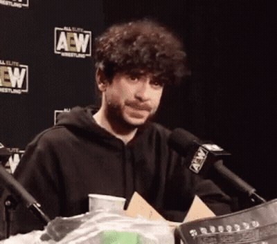 Man In Black Hoodie With AEW Microphone GIF