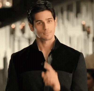 Man In Black Jacket Adjusting Collar GIF