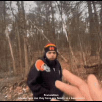 Man In Black Jacket And Beanie With Number 66 In Woods GIF
