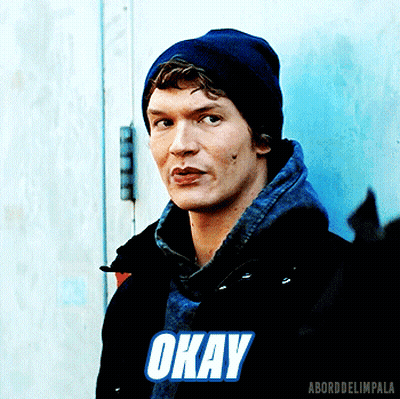 Man In Black Jacket And Blue Beanie Saying Okay GIF