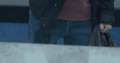Man In Black Jacket And Blue Jeans Holding Jacket GIF