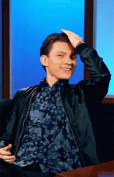 Man In Black Jacket And Floral Shirt Sitting On Couch GIF