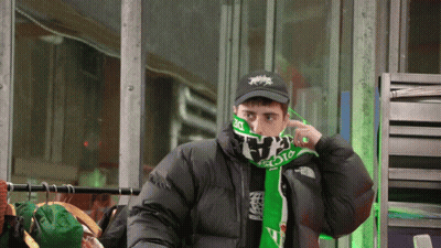 Man In Black Jacket And Green Scarf Saying The North Face GIF