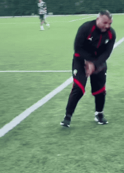 Man In Black Jacket And Red Shorts On Soccer Field GIF