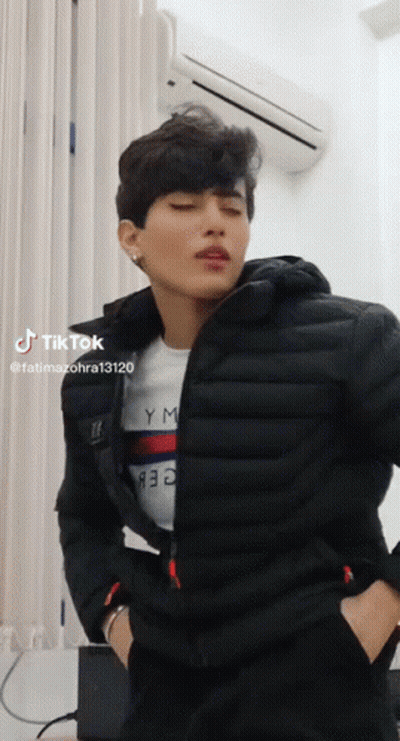 Man In Black Jacket And Tommy Hilfiger Shirt By Air Conditioner GIF