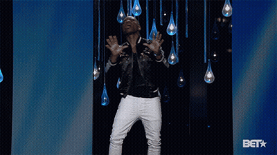 Man In Black Jacket And White Pants In Front Of BET Logo GIF