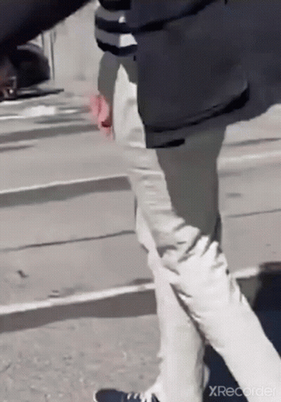 Man In Black Jacket And White Pants Walking GIF