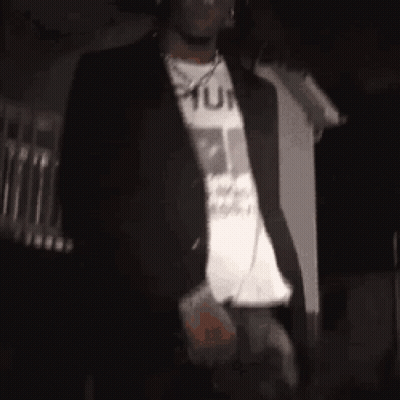 Man In Black Jacket And White Shirt In Dark GIF