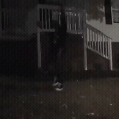Man In Black Jacket And White Shirt In Dark GIF