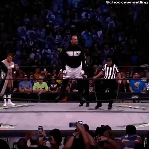 Man In Black Jacket And White Shorts In Wrestling Ring GIF