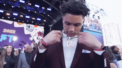 Man In Black Jacket At Microphone With NFL Logo GIF