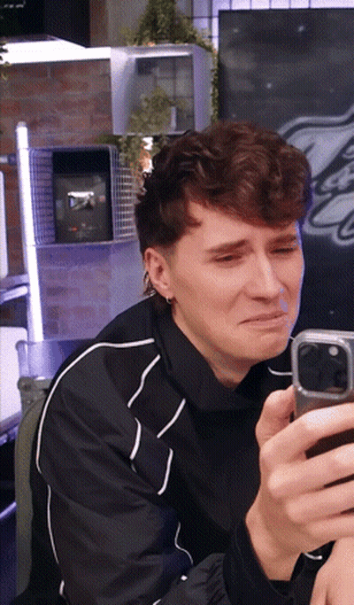 Man In Black Jacket Crying With Cell Phone GIF