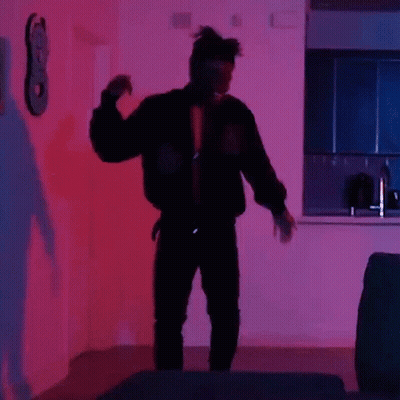 Man In Black Jacket Dancing In Purple Light GIF