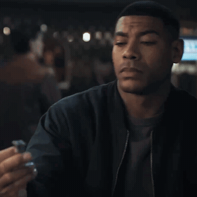 Man In Black Jacket Eyes Closed Holding Something GIF