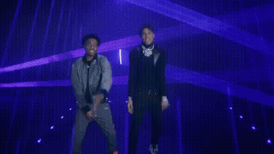 Man In Black Jacket Facing Blue Lights GIF