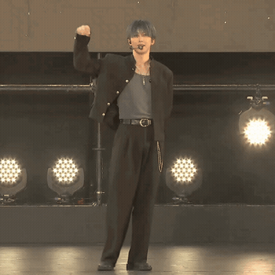 Man In Black Jacket Facing Row Of Lights GIF