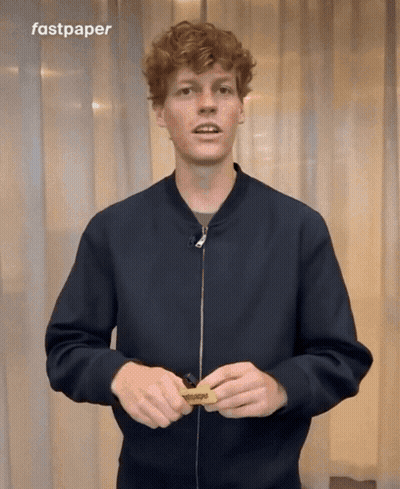 Man In Black Jacket Holding Fastpaper Sign GIF