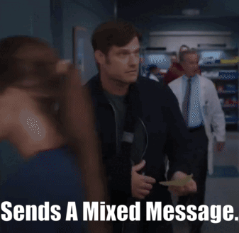 Man In Black Jacket Holding Paper Says Sends A Mixed Message GIF