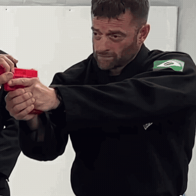 Man In Black Jacket Holding Red Gun GIF
