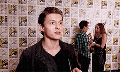 Man In Black Jacket In Front Of Comic Book Wall GIF