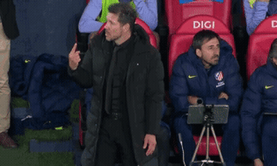 Man In Black Jacket In Front Of Red Seats Saying Digi GIF