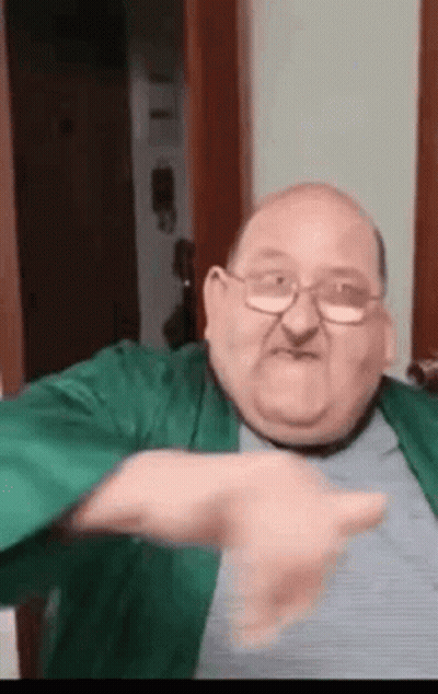Man In Black Jacket In Front Of Red Seats Saying Digi GIF