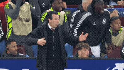 Man In Black Jacket In Front Of Stour Sports Sign GIF