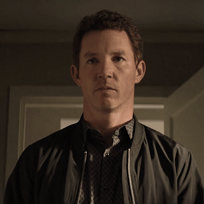 Man In Black Jacket Looking At Camera GIF