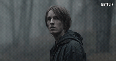 Man In Black Jacket Looking At Netflix Logo GIF
