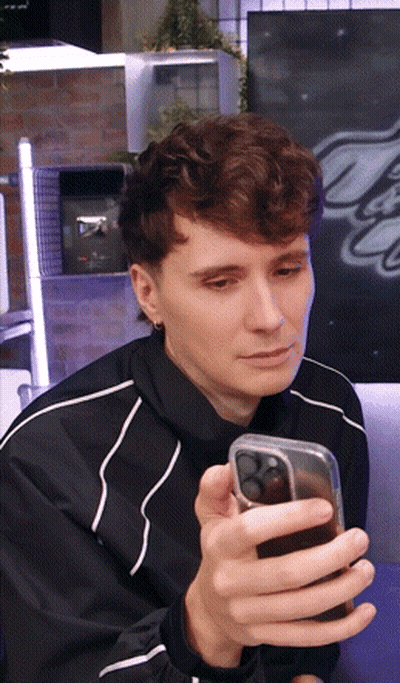 Man In Black Jacket Looking At Phone GIF
