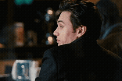 Man In Black Jacket Looking Over Shoulder GIF