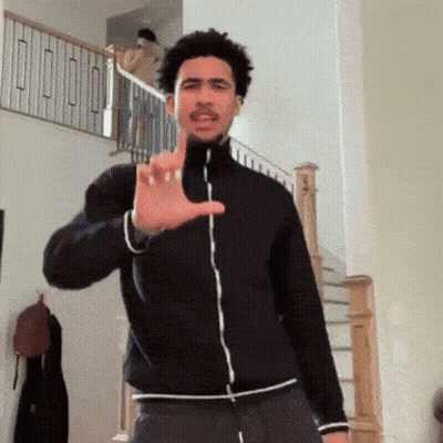 Man In Black Jacket Making Hand Gesture GIF